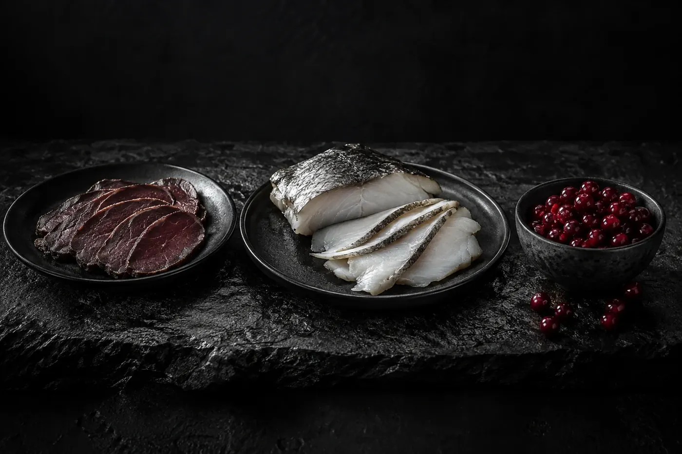 Оленина, северная рыба и брусника на тёмном камне